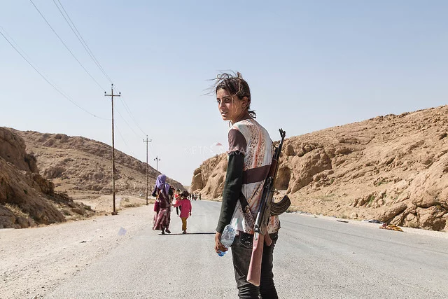 Yezidi girl carries an assault rifle to protect her family against ISIS credits Adam Rifkin via Flickr ( (CC BY 2.0)